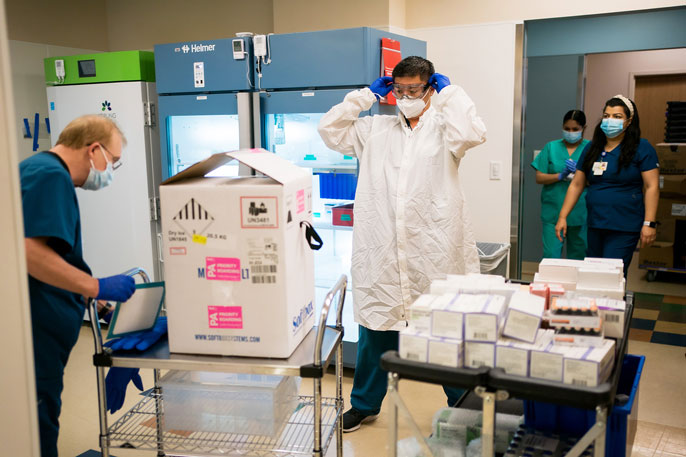 Personnel prepare to unpack vaccine