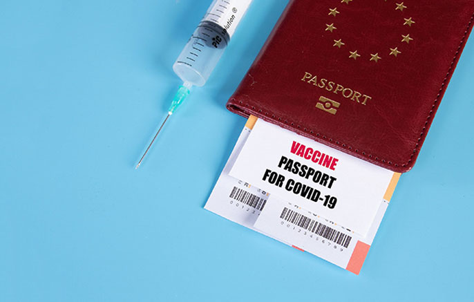 Passport next to a syringe