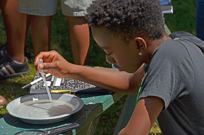 Student looks at something in water