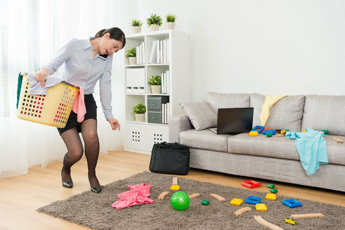 Woman picking up toys from floor