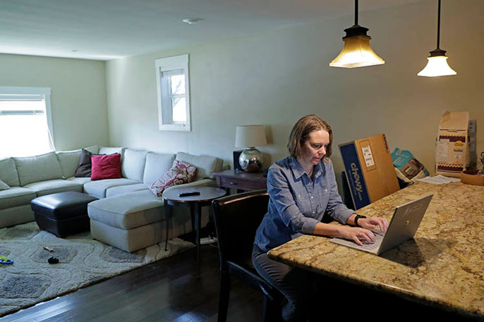 Woman working at kitchen island at home