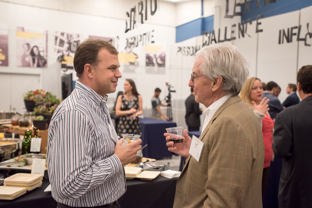 Michael Hayden speaks to David Hind at a networking event